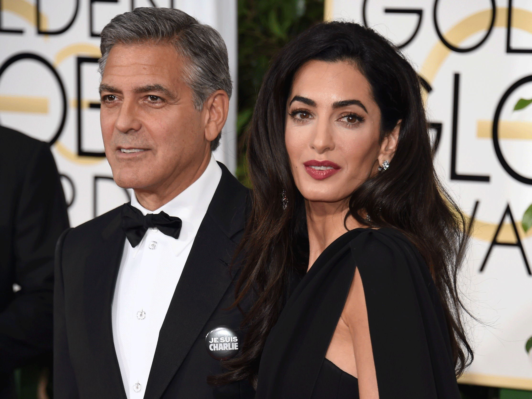 George Clooney wearing a 'Je suis Charlie' badge with his wife, Amal (Getty)