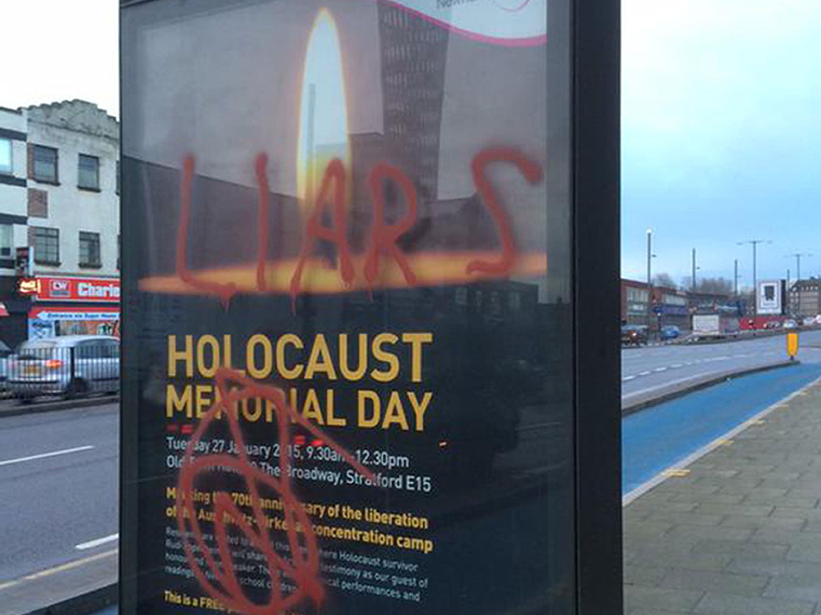 Graffiti on posters advertising Newham Council's Holocaust Memorial Day event in Stratford, London