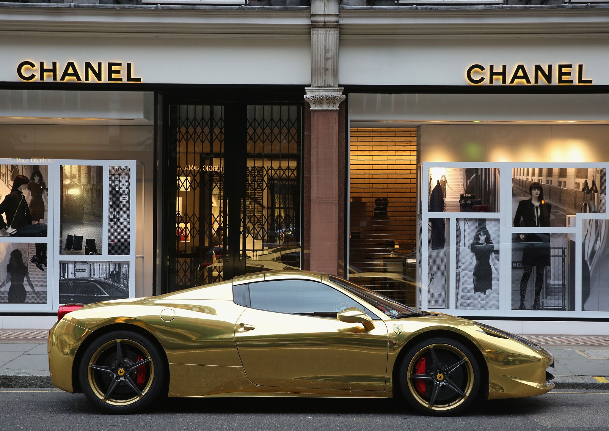 A Gold Ferrari sits outside Chanel on Sloane Street