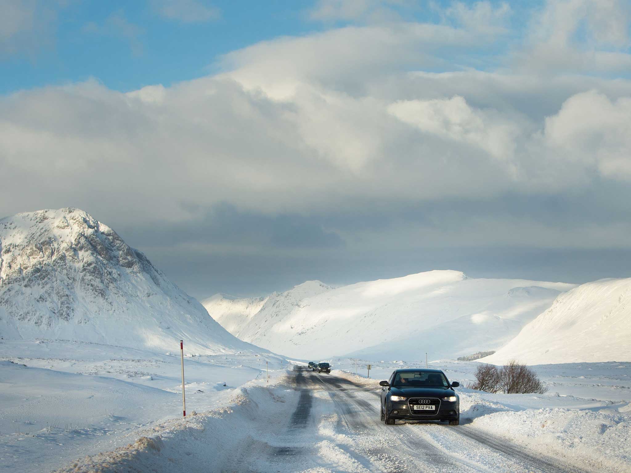 Cars make their way slowly through the treacherous conditions in the highlands