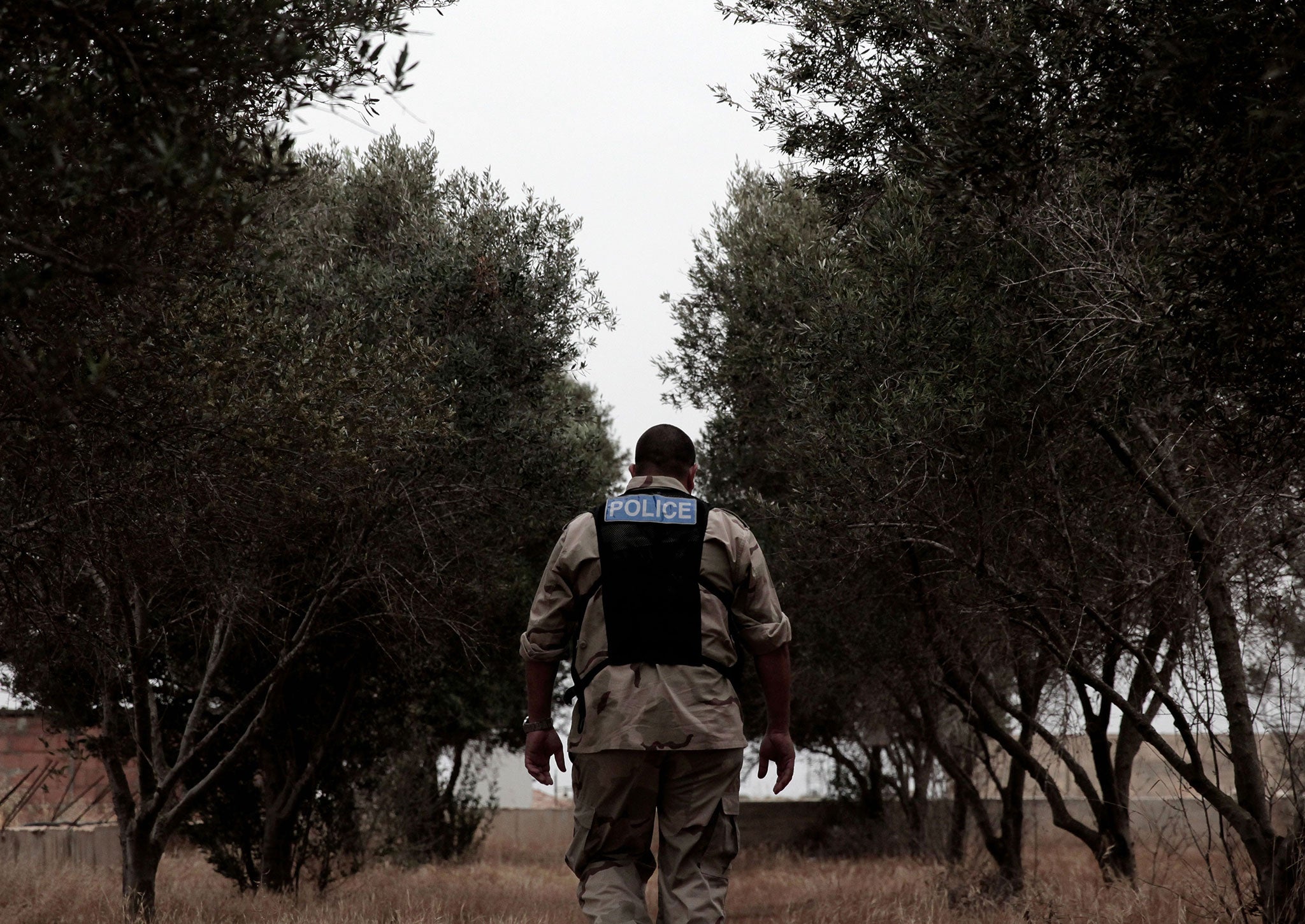 A British army policeman tracks down locations of traps used by poachers to catch migratory birds on a British sovereign base in the region of Dhekelia
