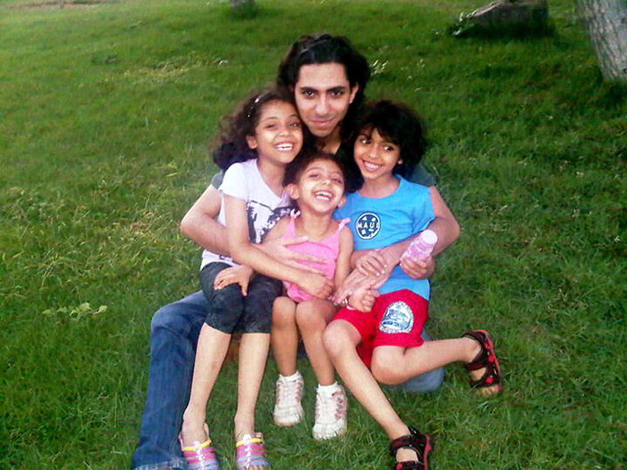 Raif Badawi, here with his children, Najwa, 11, Miriam, seven, and Terad, 10, is facing 10 years in jail, a heavy fine, and 1,000 lashes