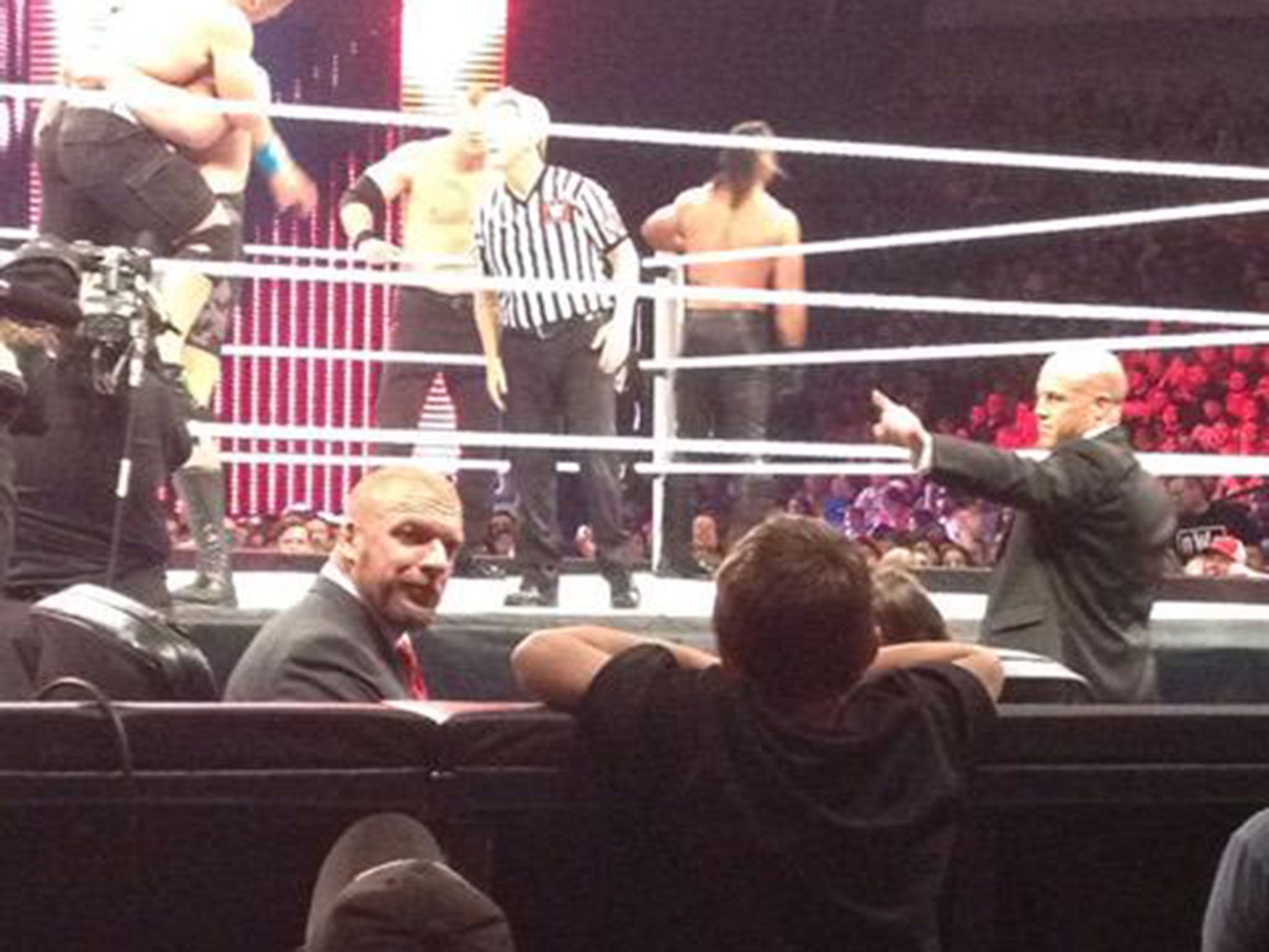 Triple H notices the fan crying at ringside