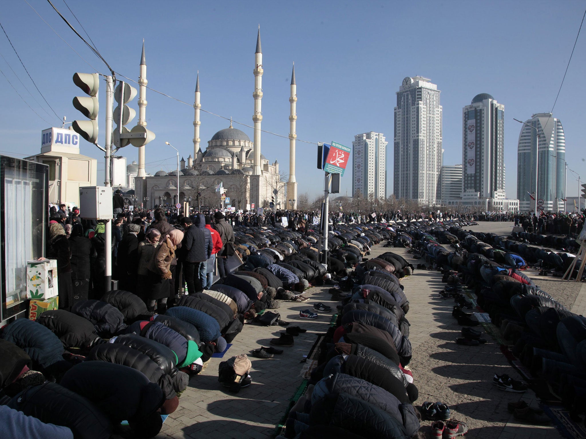 Chechen Muslims pray during a mass rally against French magazine Charlie Hebdo