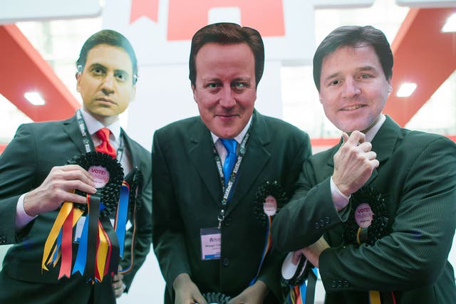 Three people wearing masks depicting Ed Miliband, David Cameron and Nick Clegg