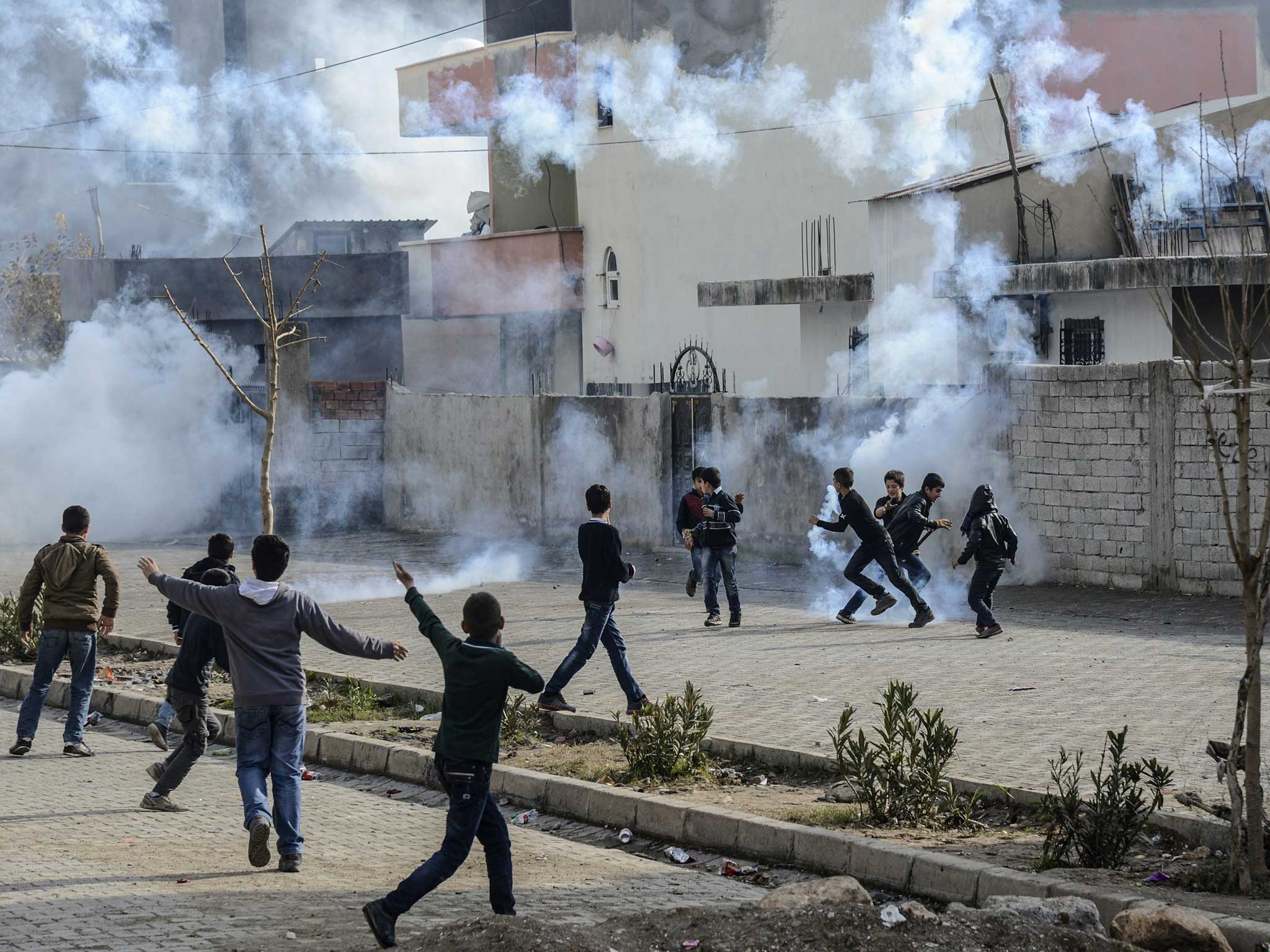 Young boys run amid the rising smoke in Cirze in late December last year, tensions have been rising in the region