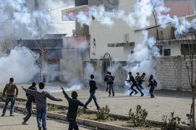 Young boys run amid the rising smoke in Cirze in late December last year, tensions have been rising in the region