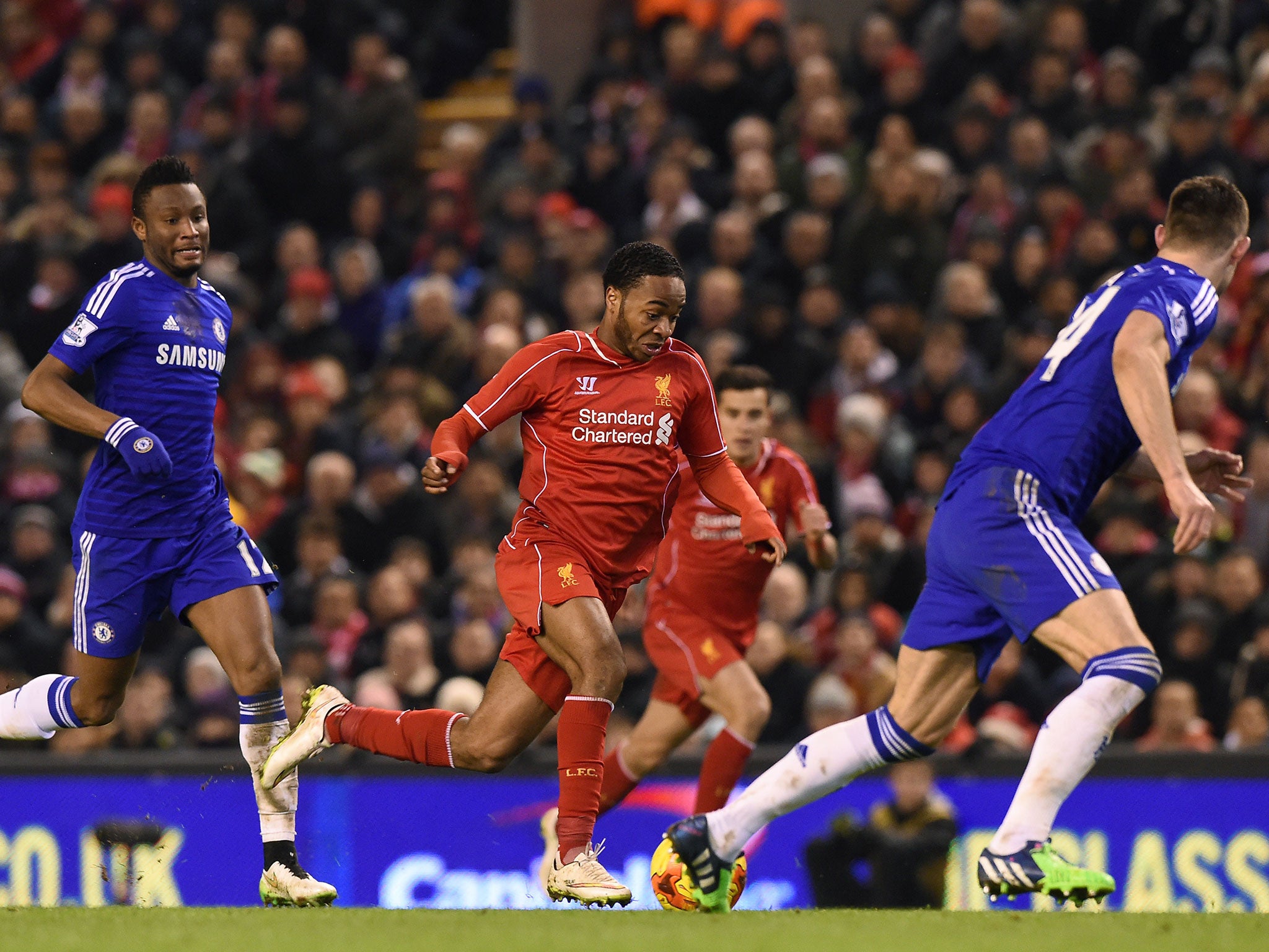 Raheem Sterling powers through the Chelsea defence