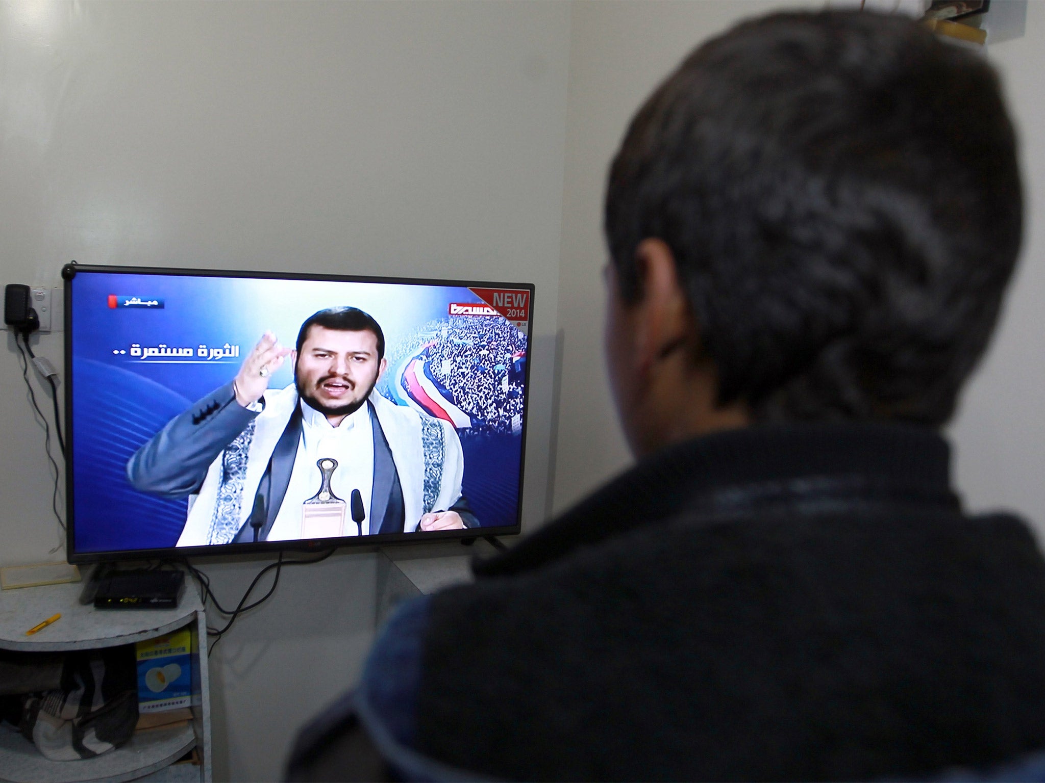 A Yemeni man watches the televised speech by Abdul Malik al-Houthi, in the capital Sanaa (Getty)