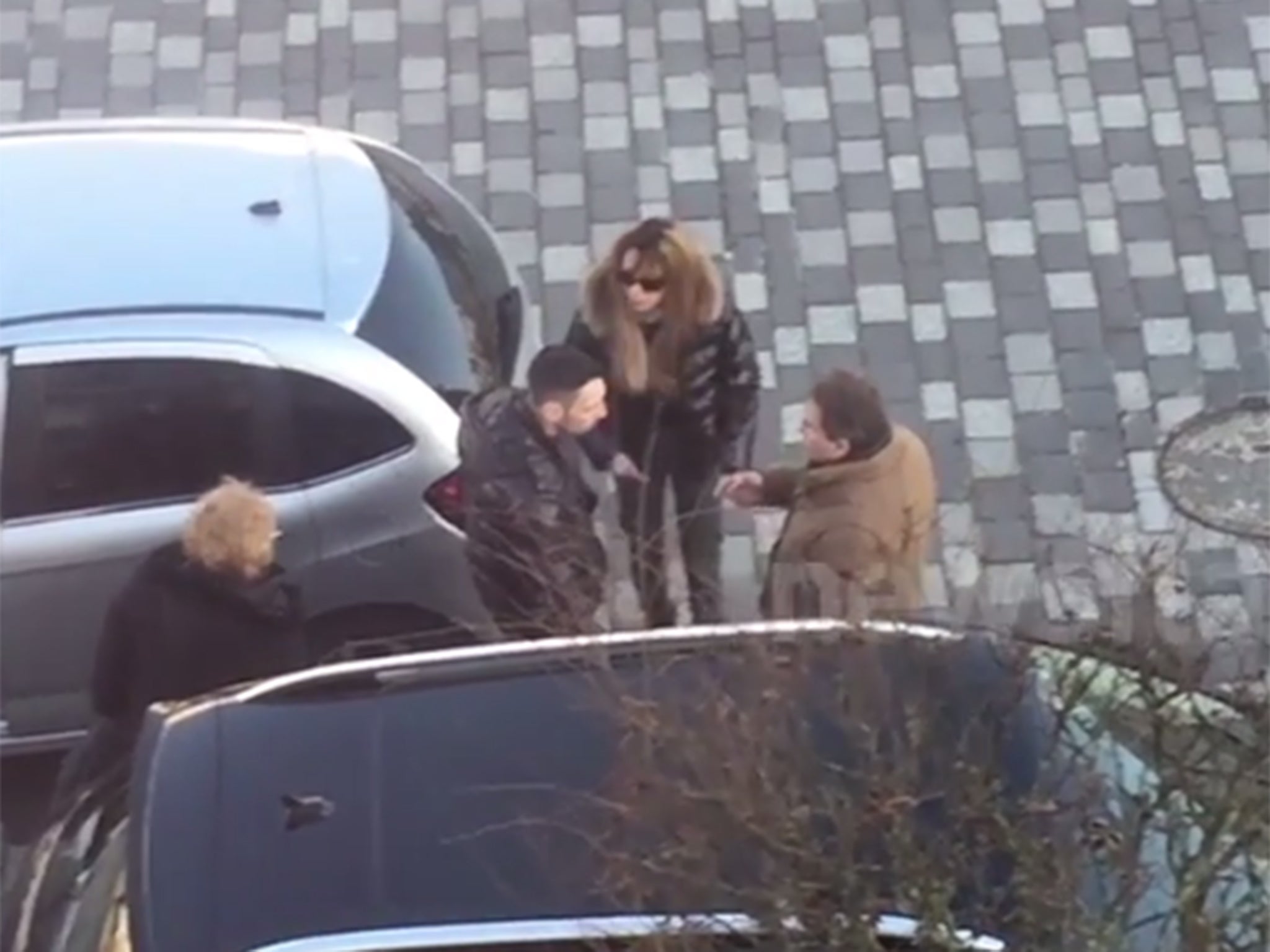 The two couple are involved in a heated dispute over the parking space