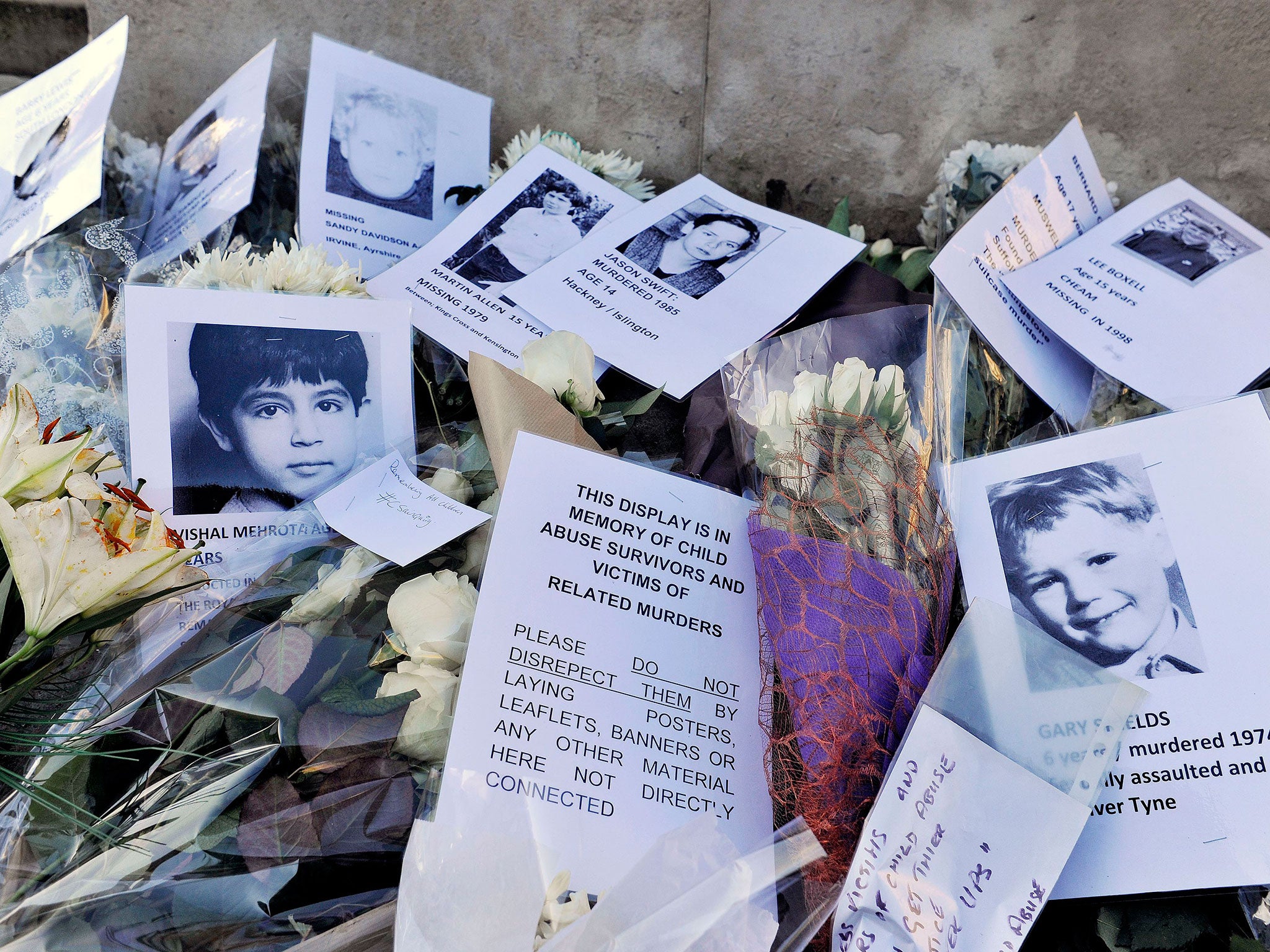 Pictures, messages and floral tributes left at Old Palace Yard in Westminster, organised by the WhiteFlowers Campaign Group in commemoration of victims and survivors of child abuse (PA)