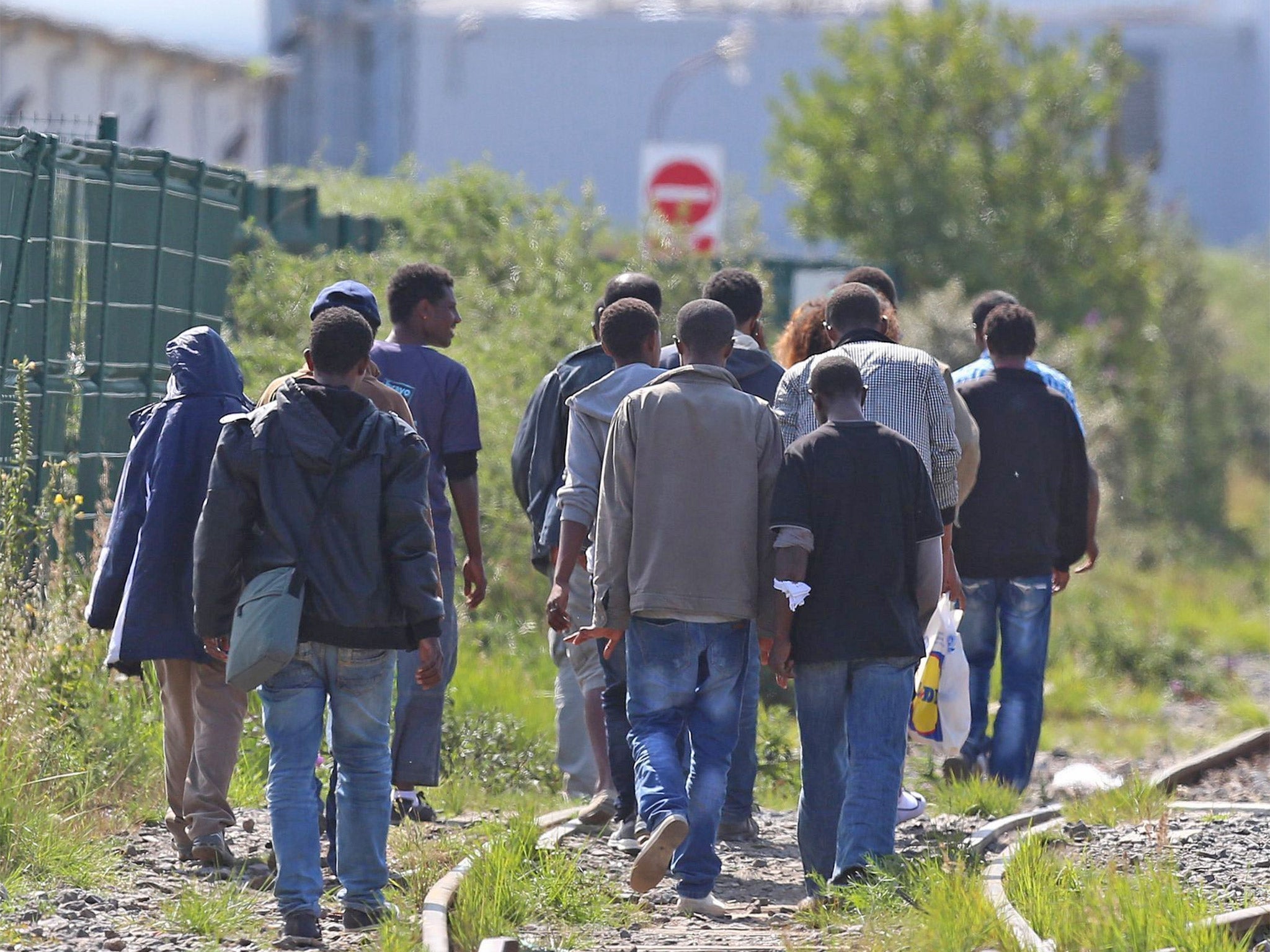 A group of migrants make their way through Calais, heading for Britain.