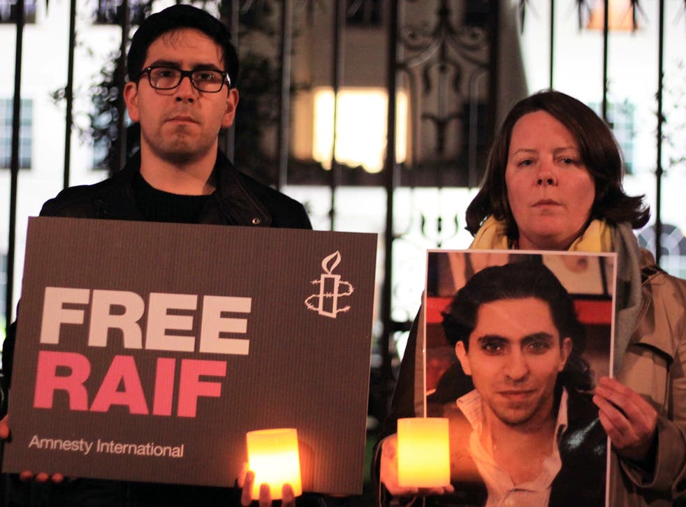 People take part in a protest by Amnesty International, for the immediate release of the Saudi blogger Raif Badawi in London, UK