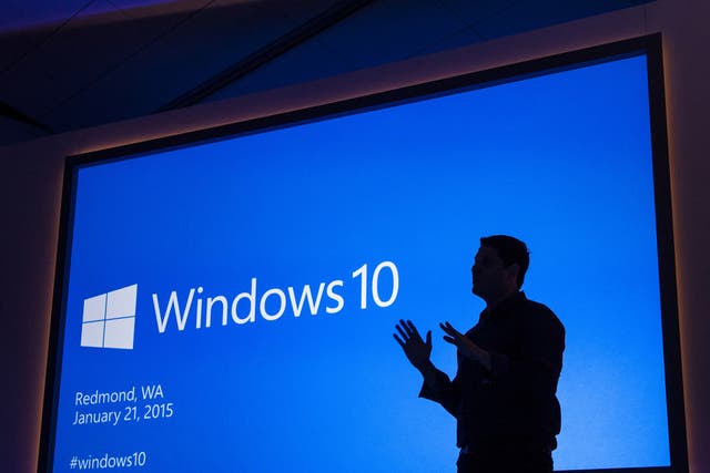 Terry Myerson silhouetted against the backdrop at the Windows 10 launch event