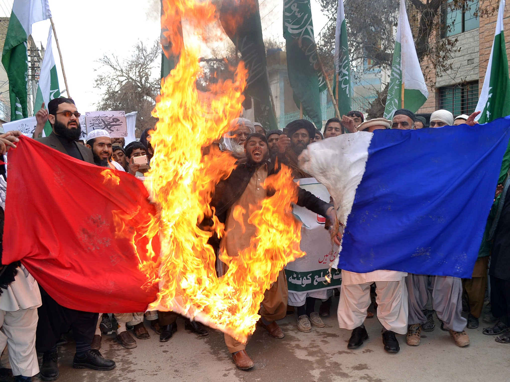 Pakistani Islamists burn a French flag during a protest against the printing of satirical sketches of the Prophet Mohammad by French magazine Charlie Hebdo in Quetta, Pakistan