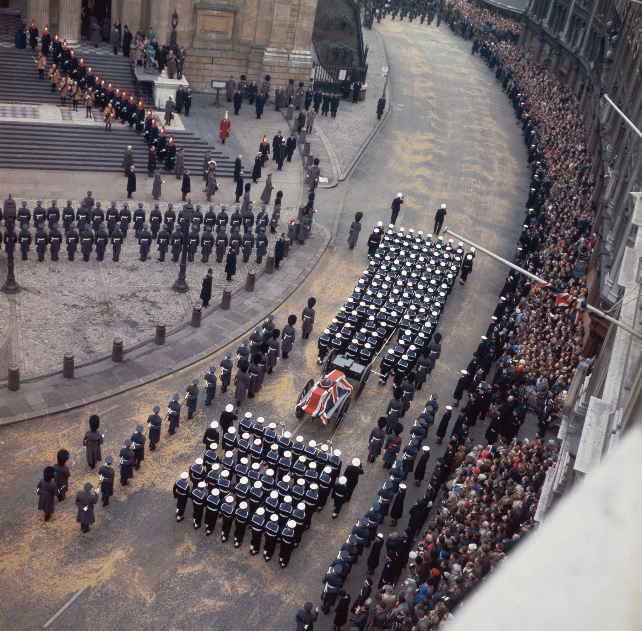 Thousands of people lined the street to see Sir Winston Churchill's coffin borne through London's streets on a gun carriage (Getty)