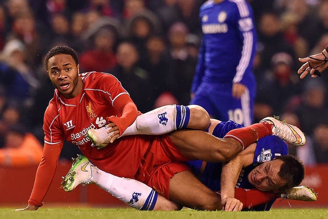 Liverpool’s Raheem Sterling tangles with John Terry of Chelsea during Tuesday’s Capital
One Cup semi-final at Anfield