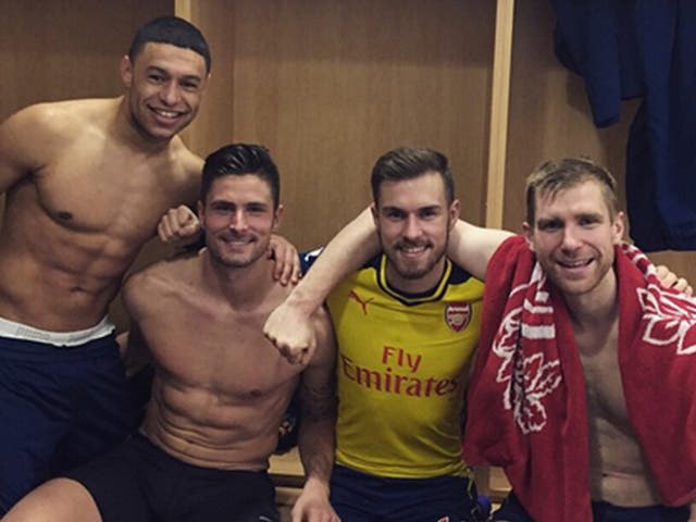 Arsenal players celebrate their win over Manchester City with a dressing room selfie