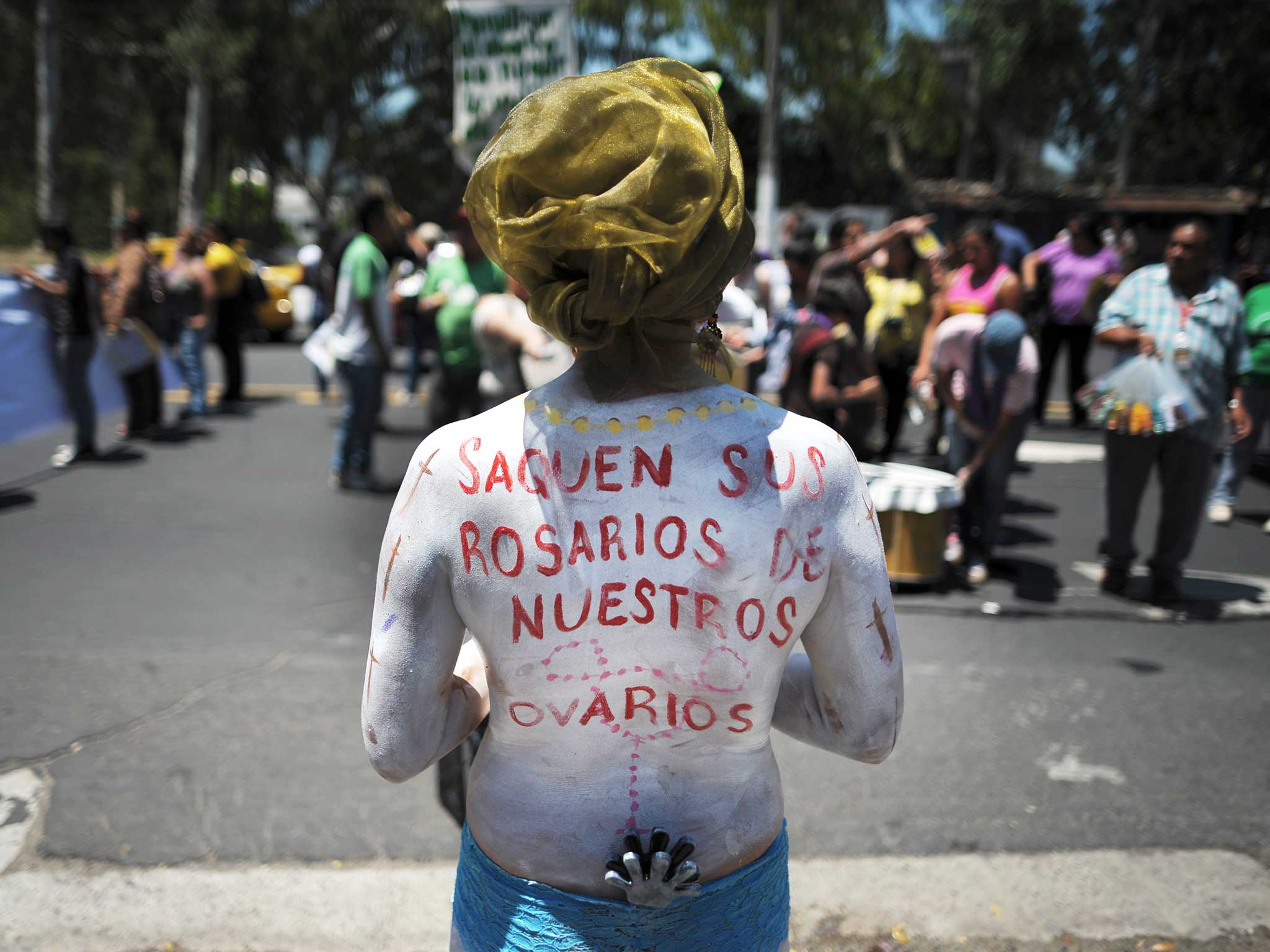 A protester painted with 'Get your rosaries out of our ovaries' on a march in 2013