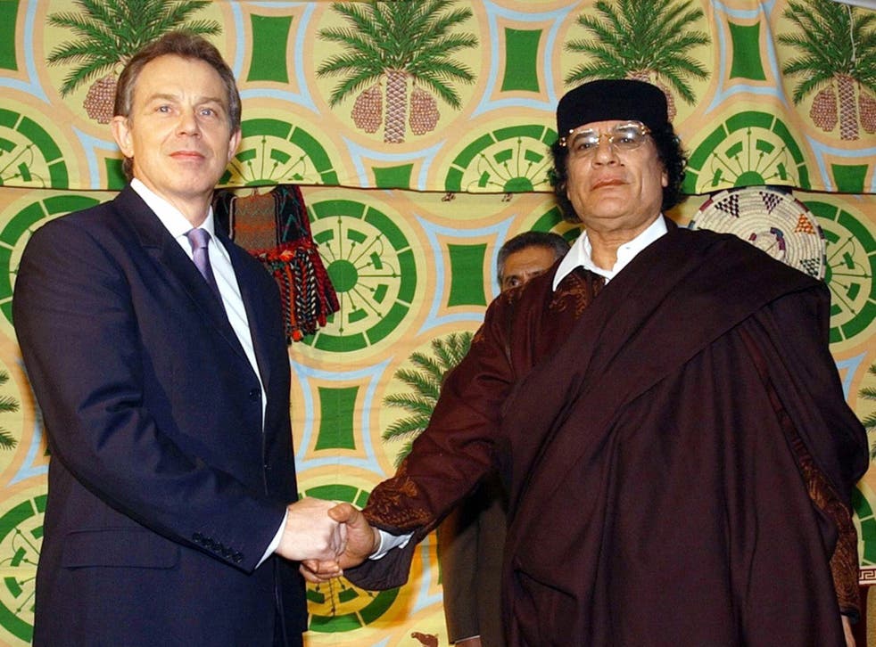 British Prime Minister Tony Blair (L) pictured shaking hands with Libyan leader Colonel Moamer Kadhafi on 25 March 2004.