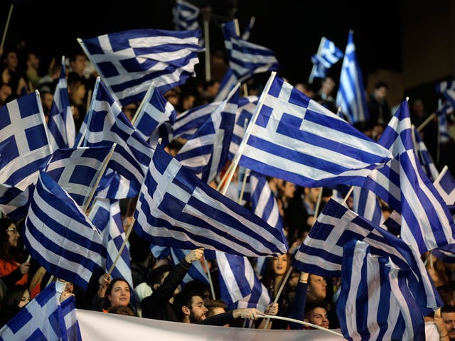 Supporters of New Democracy wave Greek flags during Antonis Samaras pre-election speech.