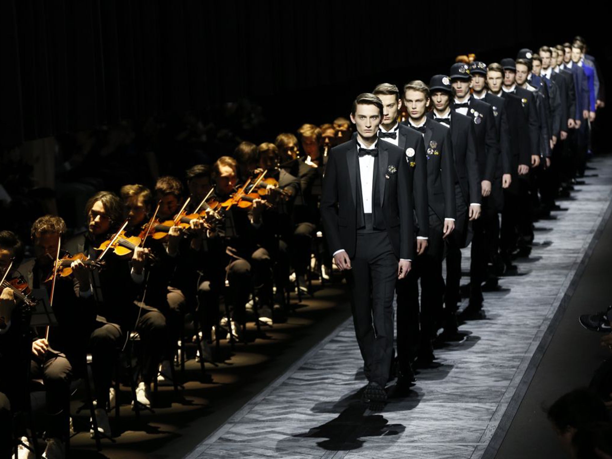 Models – and musicians – on the catwalk in Dior Homme for the men’s 2015/16 fashion show in Paris (AFP)