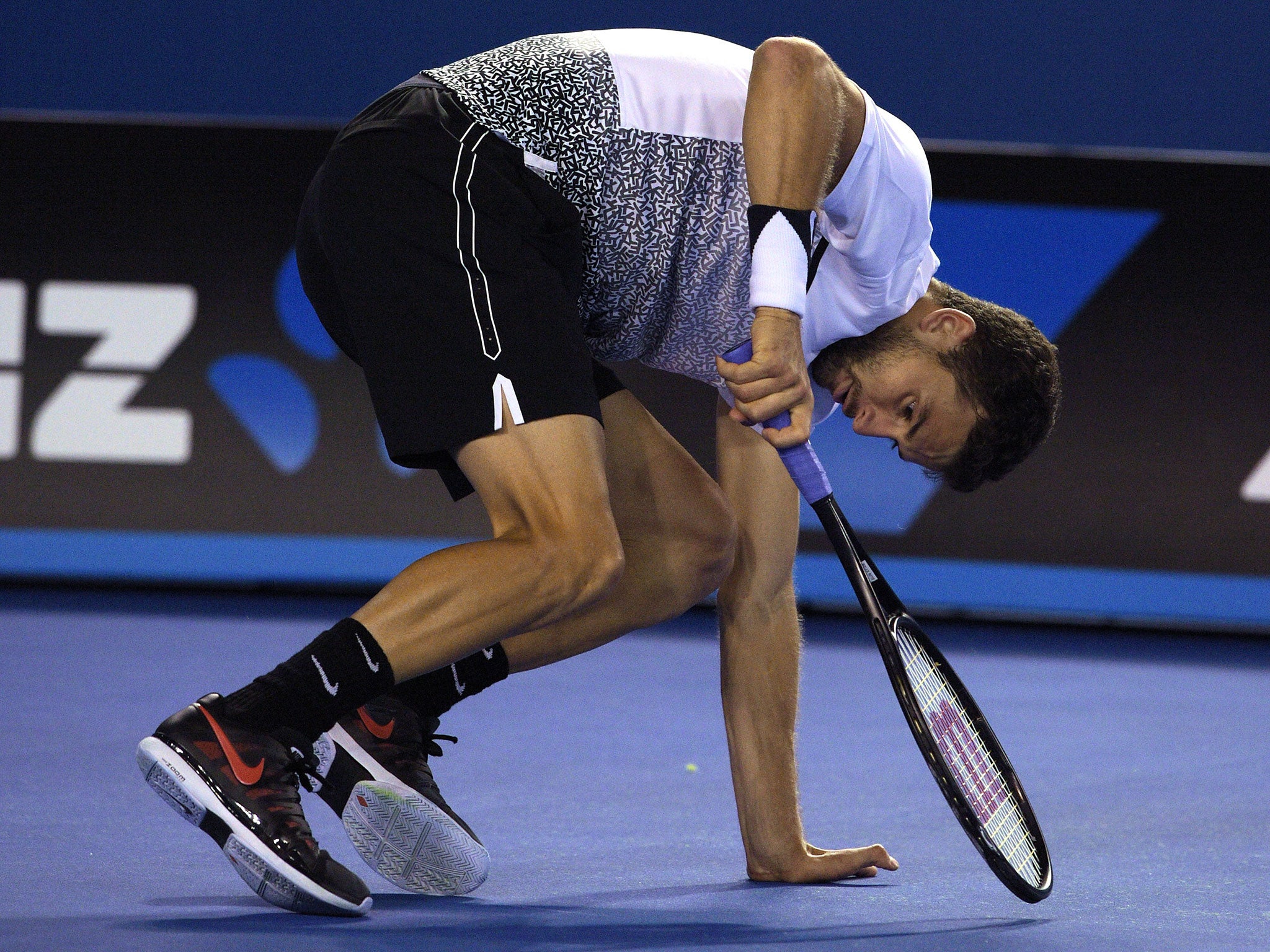 Dimitrov falls over at the Rod Laver Arena