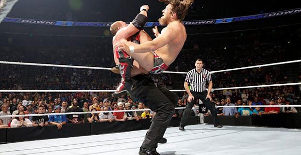 Daniel Bryan (right) hits the running knee on Kane