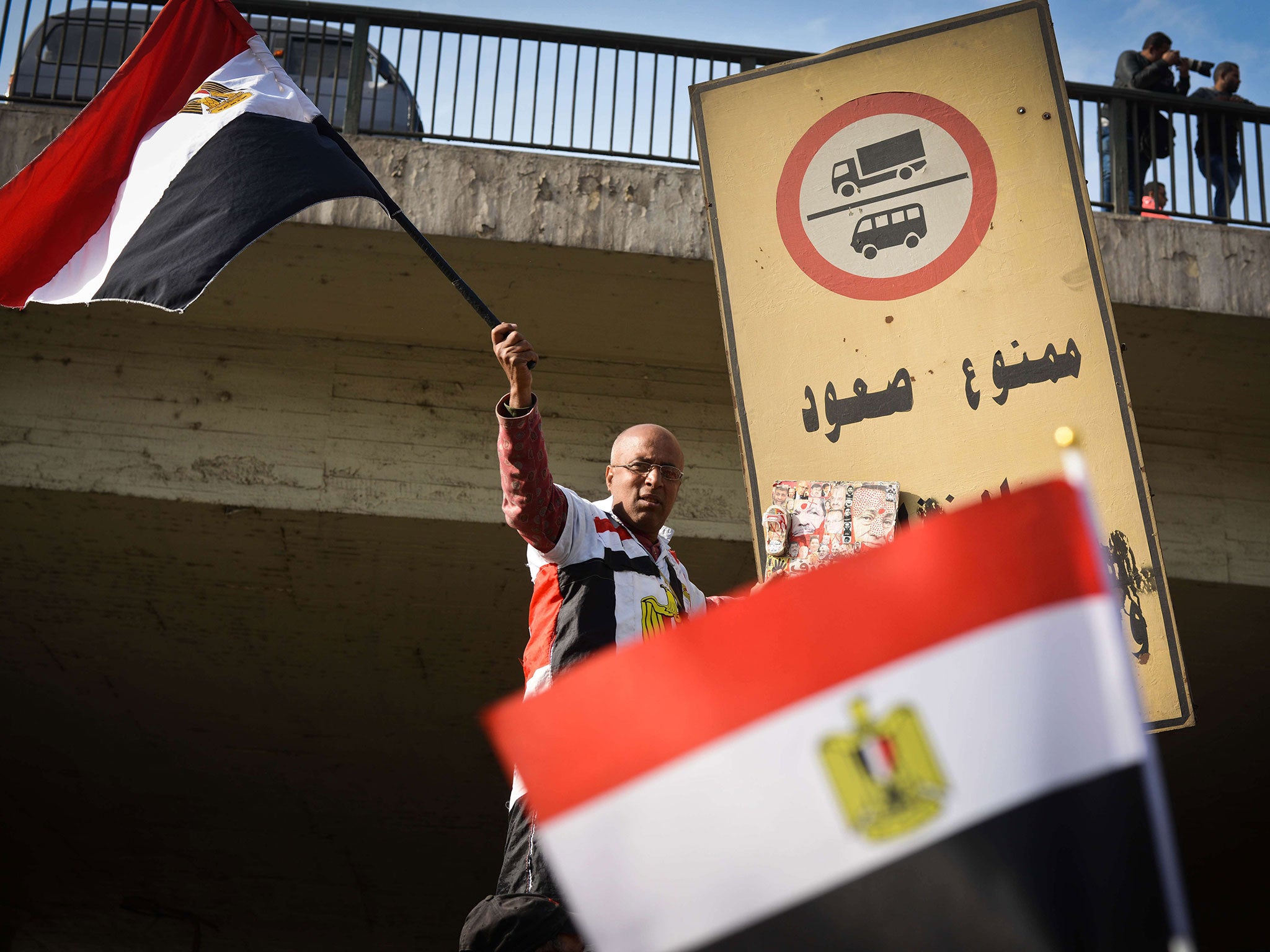 A supporter of Egyptian President Abdel Fattah al-Sisi waves his national flag during a demonstration in Cairo on January 25, 2015