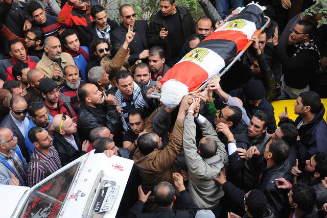 People carry the coffin of Shaima al-Sabbagh during her funeral, Alexandria, Egypt, 25 January 2015