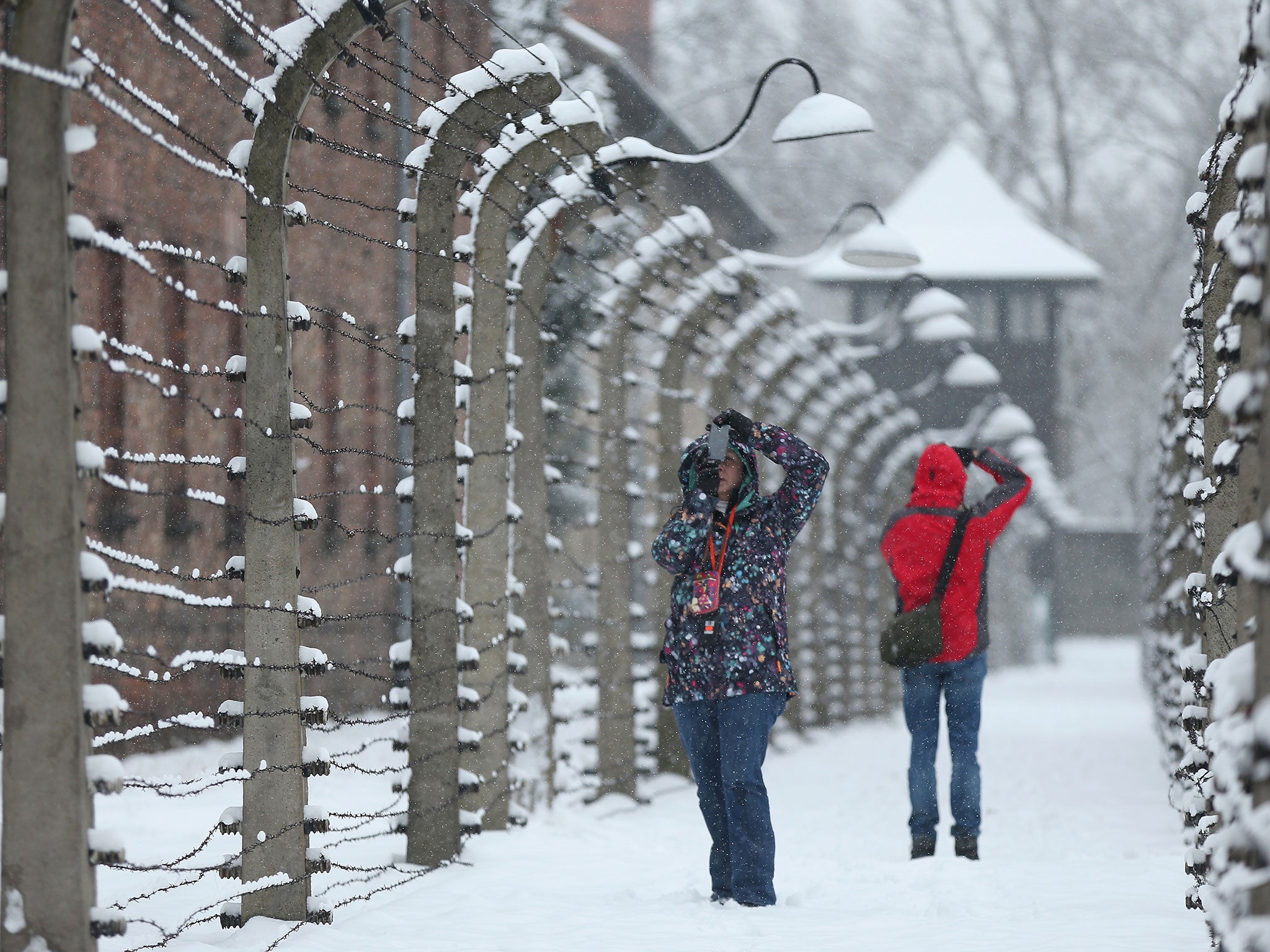 Visitors at Auschwitz in the snow. A ceremony today will mark the 70th anniversary of its liberation by the Soviet army in 1945