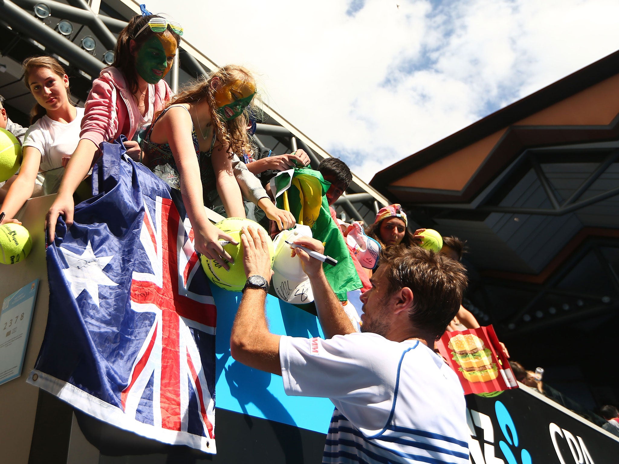 Stan Wawrinka signs autographs for fans after seeing off Guillermo Garcia-Lopez