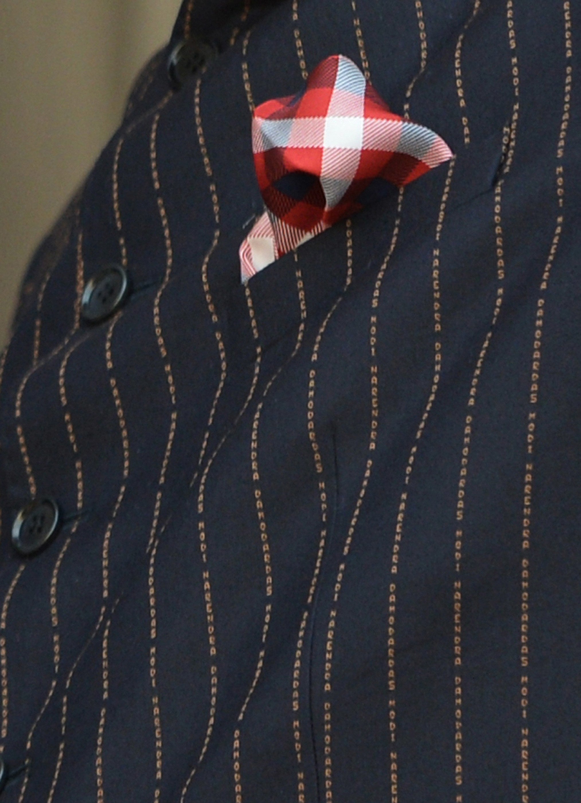 The pinstripes on Narendra Modi's suit spelled his full name