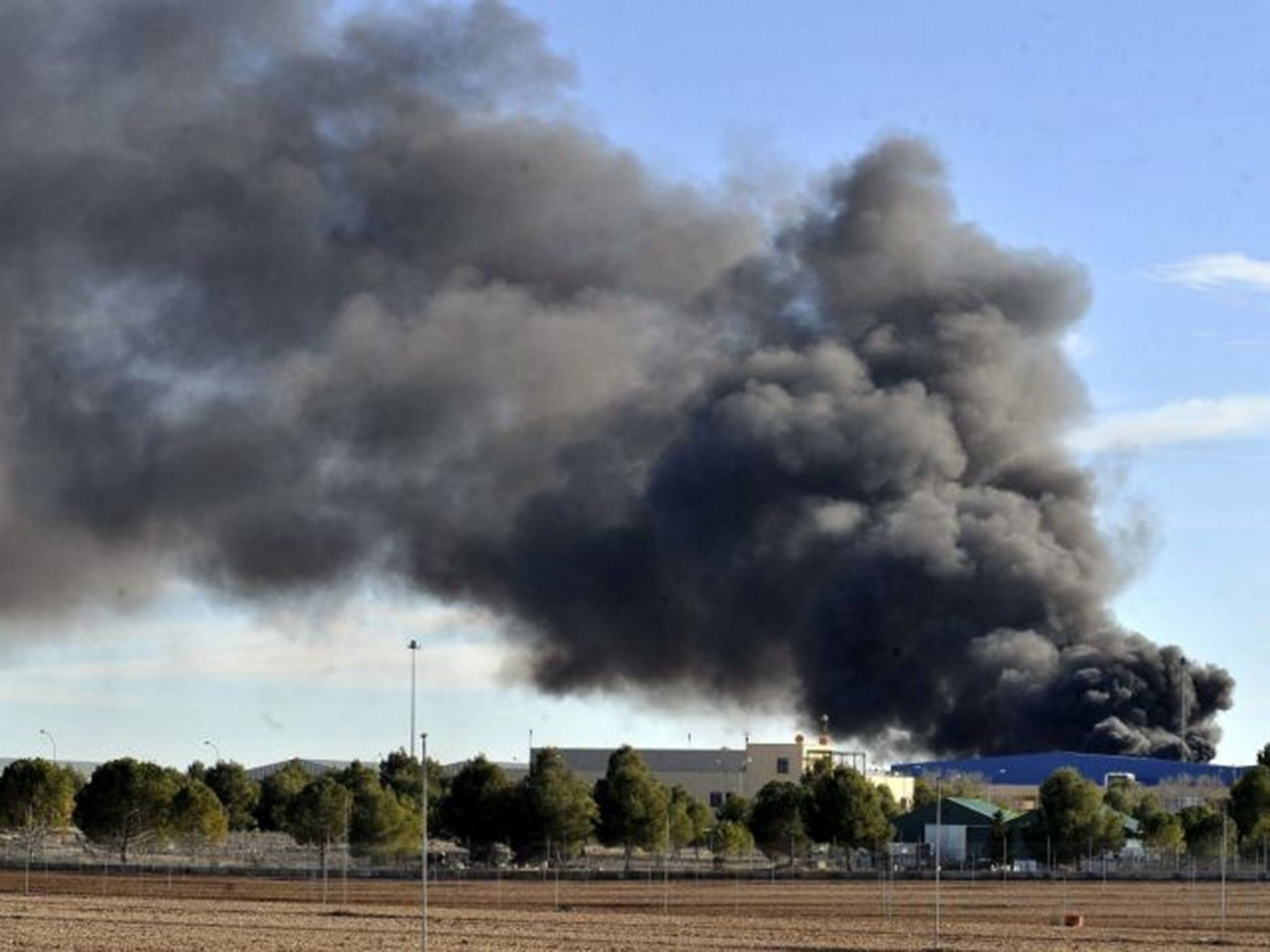 Smoke rises after a Greek F-16 aircraft crashed at Los Llanos air base in Albacete