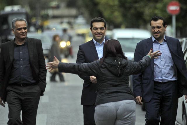 A voter greets new Greek PM Alexis Tsipras in the street following his election victory (EPA)