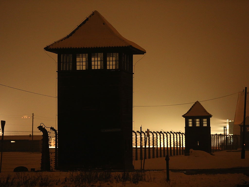 Guard towers and barbed wire fences stand at the former Auschwitz-Birkenau concentration camp