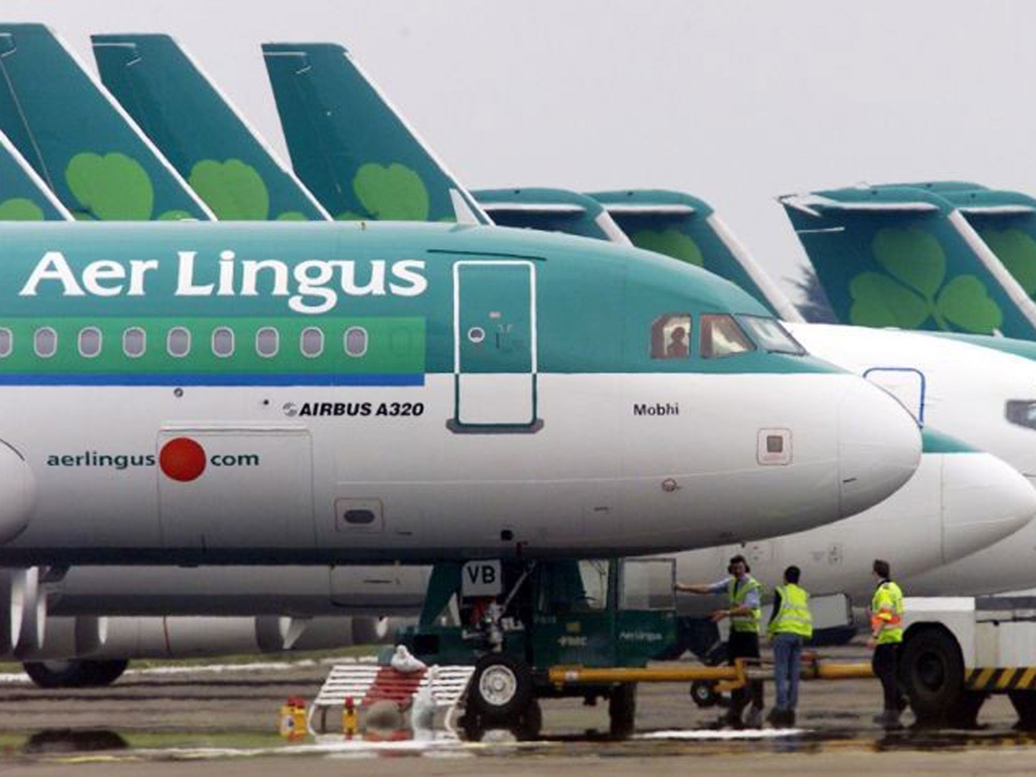 Ground crew are seen parking an Aer Lingus Airbus A320 away from the passenger terminals at Dublin Airport in 2002