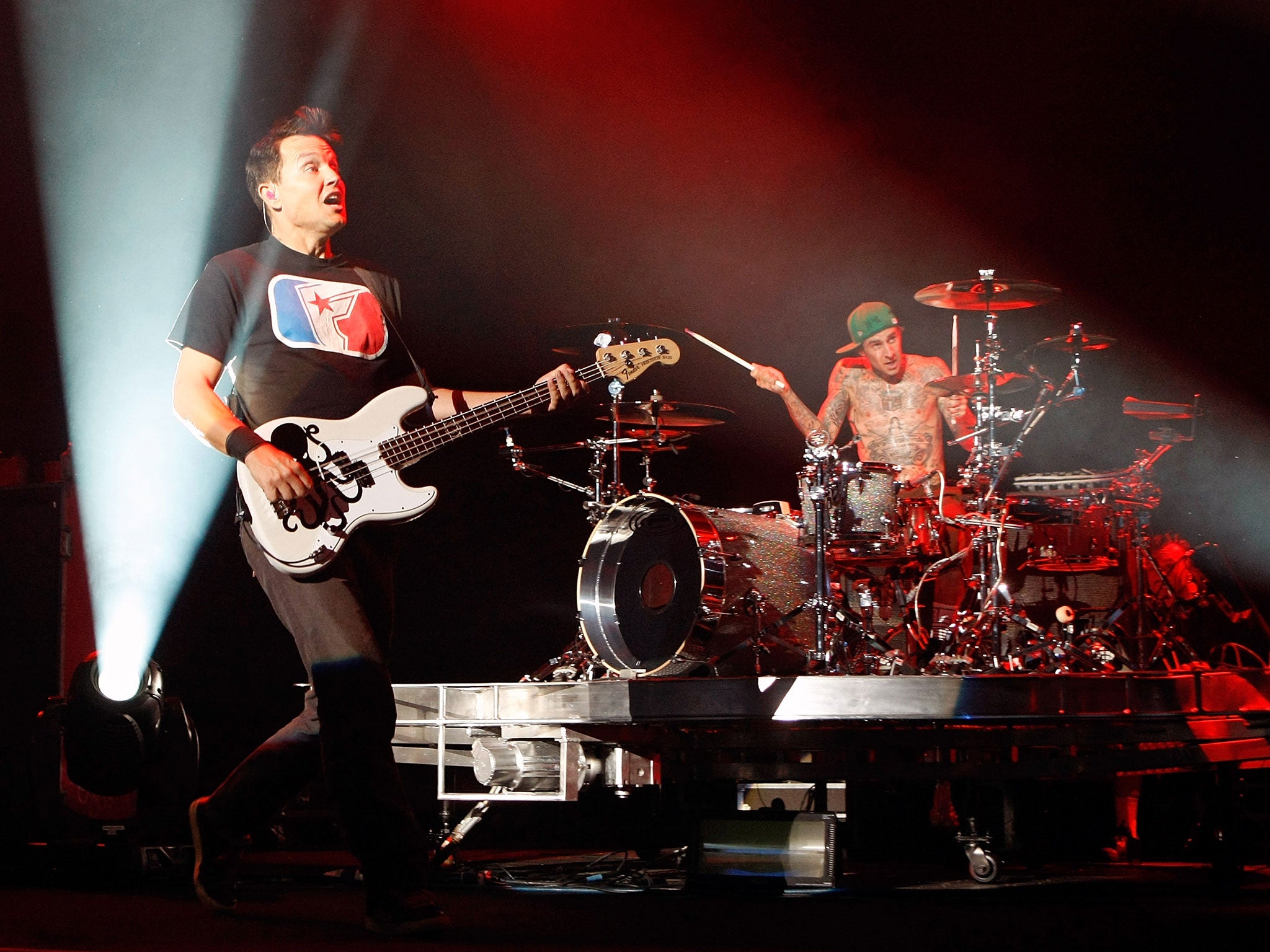 Blink-182 singer/bassist Mark Hoppus (L) and drummer Travis Barker perform onstage