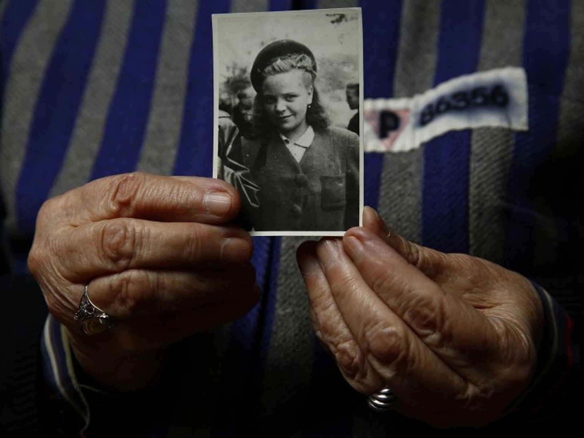 Auschwitz death camp survivor Jadwiga Bogucka, 89, holds a picture of herself from 1944