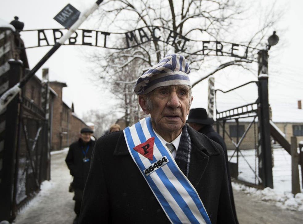 Auschwitz survivor Miroslaw Celka walks out the gate on Holocaust Memorial Day 2015