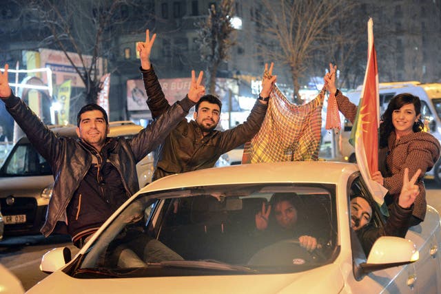 Kurds celebrate as they drive along a street in Diyarbakir, southeastern Turkey, on January 26, 2015