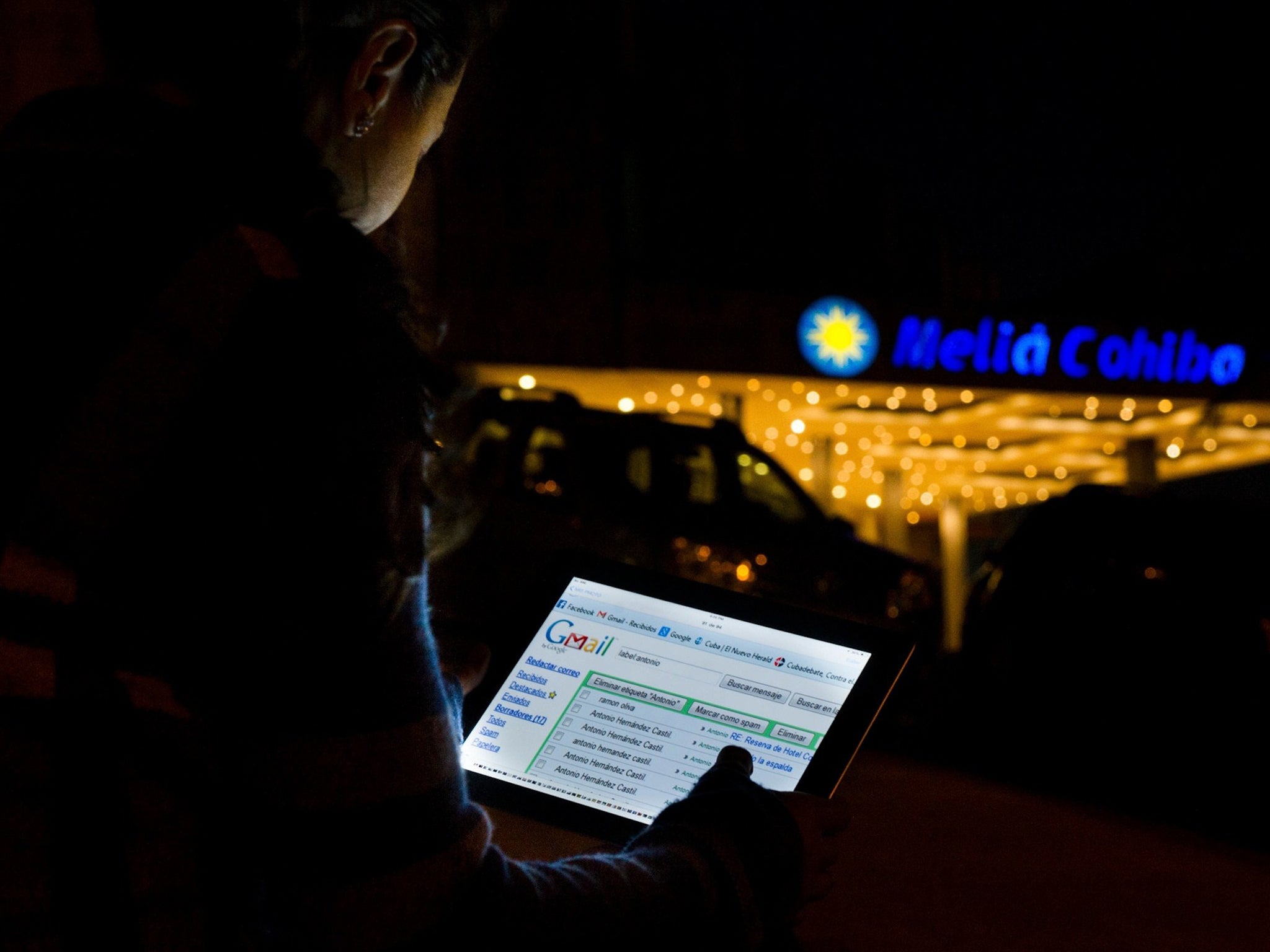 A Cuban uses an illegal wi-fi connection to surf the internet, on November 28, 2014, in Havana