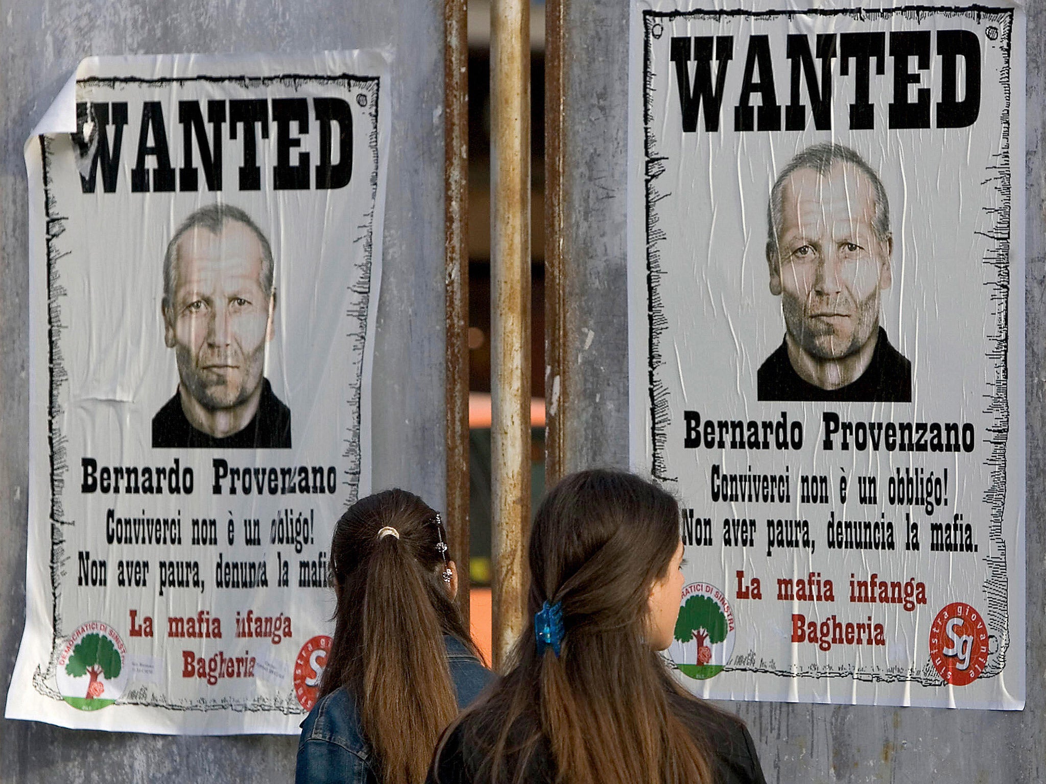 Posters seeking the whereabouts of Corleone head Bernardo Provenzano, before his arrest in 2006 (Getty)