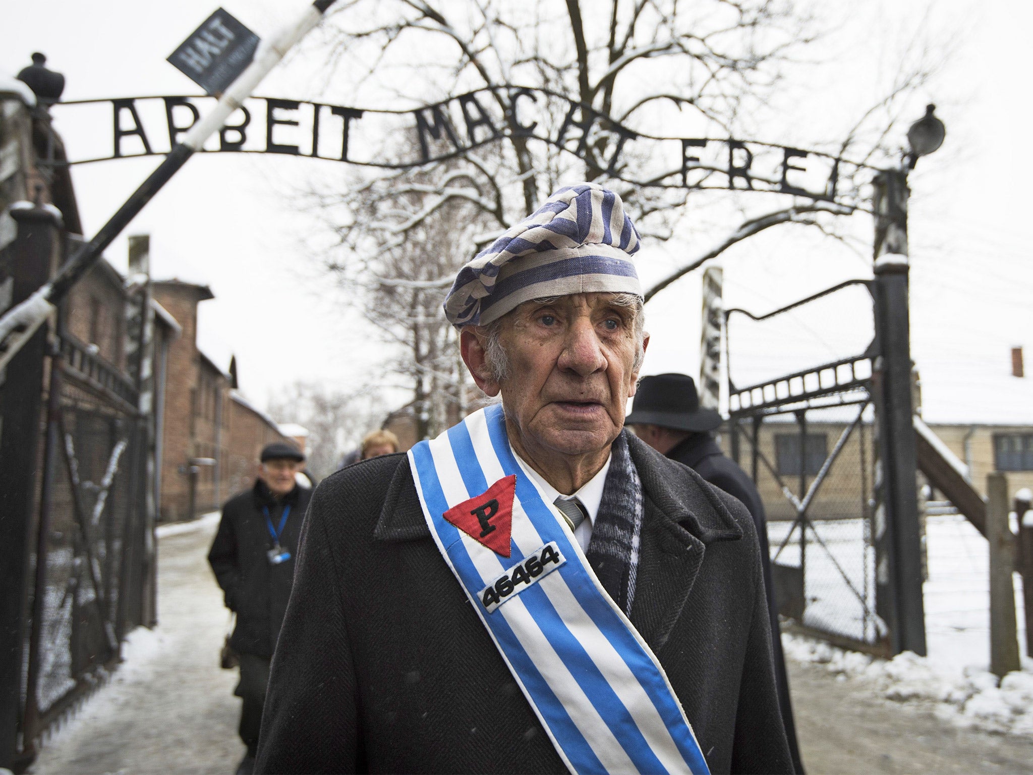 Auschwitz survivor Miroslaw Celka at the infamous ‘Arbeit Macht Frei’ gate