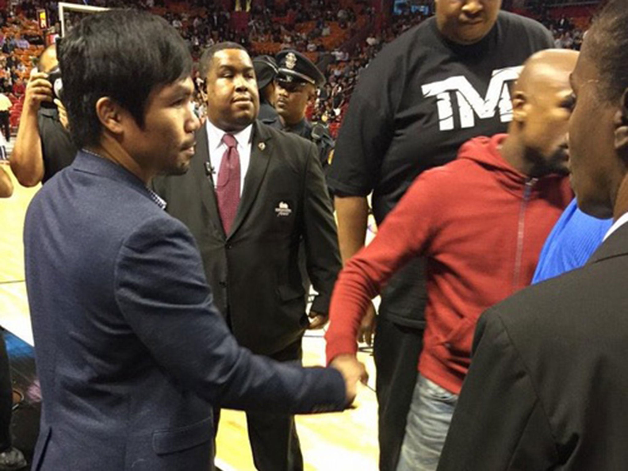 Manny Pacquiao and Floyd Mayweather shake hands at the Miami heat NBA game last night