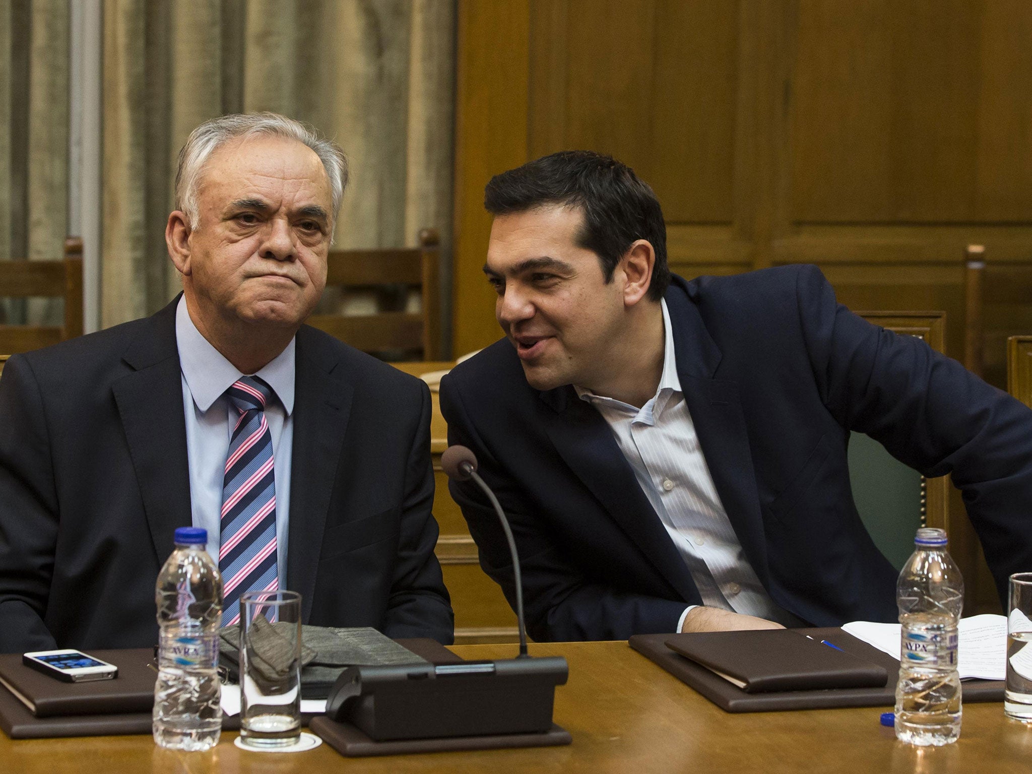 Greek Prime Minister Alexis Tsipras (right) talks to Deputy Prime Minister Yannis Dragasakis during the first meeting of new cabinet post elections in the parliament building in Athens January 28, 2015