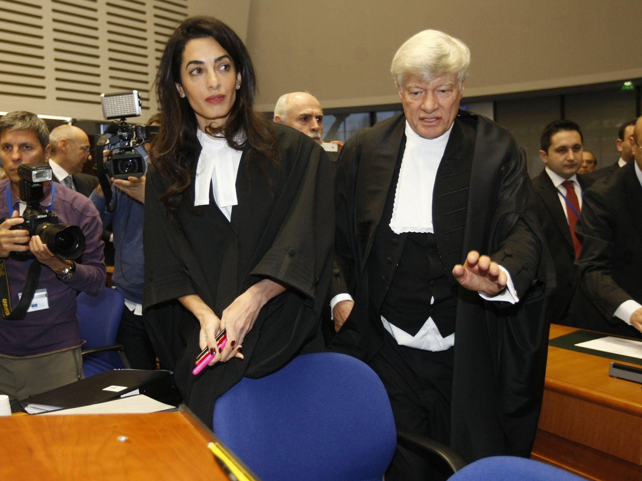Geoffrey Robertson, right, a member of a legal team representing Armenia, takes his seat with his colleague Amal Clooney as they arrive at the European Court of Human rights 