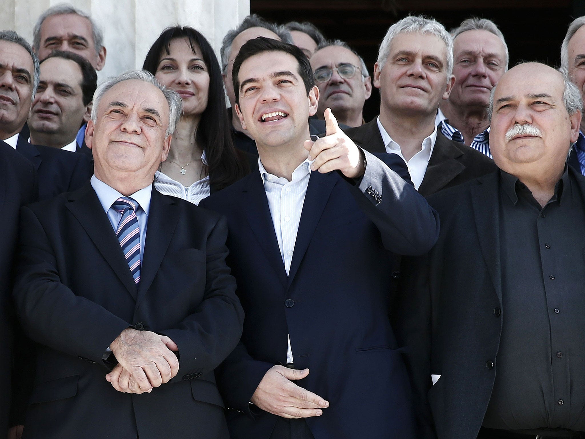 Greek Prime Minister Alexis Tsipras (centre) gestures next to Deputy Prime Minister Yannis Dragasakis (left) and Interior and Administrative Reconstruction Minister Nikos Voutsis after the first meeting of the new cabinet on January 28, 2015