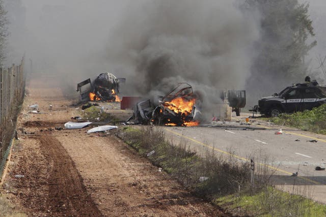 Burning vehicles are seen near the village of Ghajar on Israel's border with Lebanon January 28, 2015