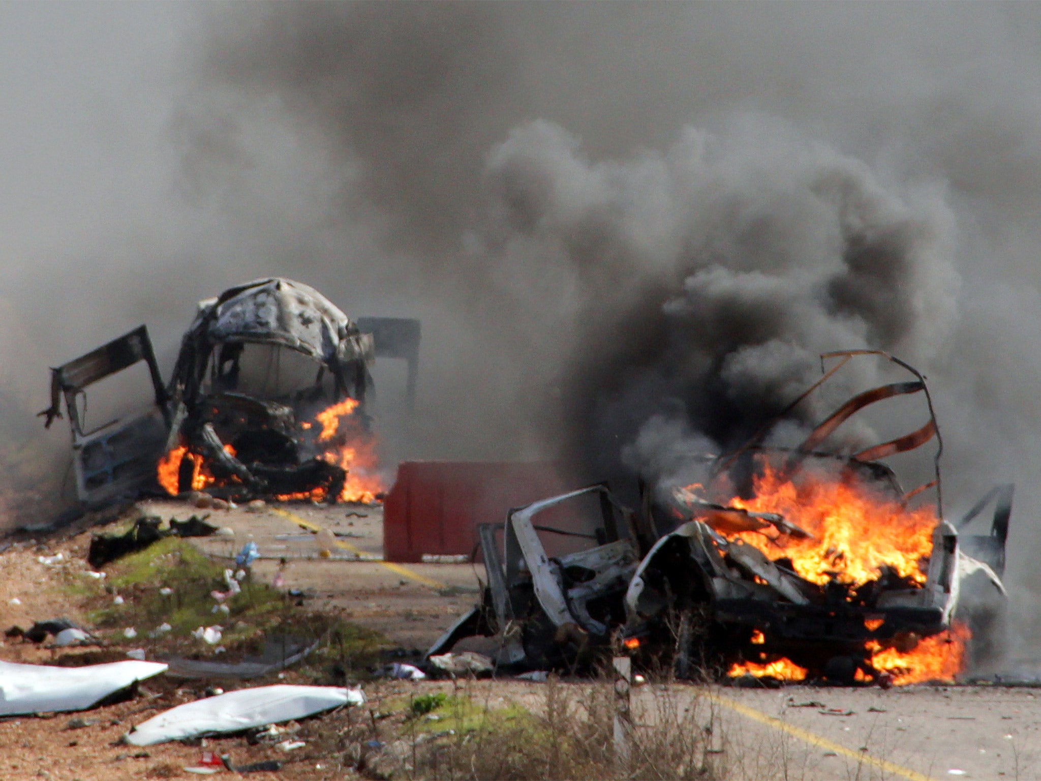 Israeli military vehicles are seen burning in the Shebaa Farms following a Hezbollah missile attack (Getty)